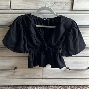 Low cut black blouse with cinched waisted and puffed sleeves